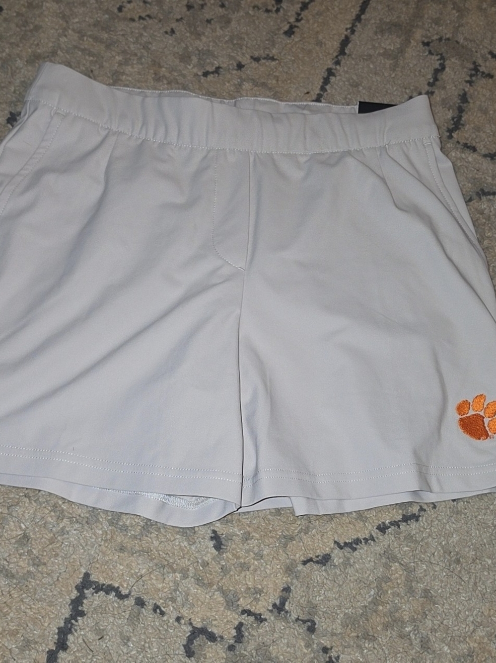 Nike Men's White Athletic Shorts with Orange Paw Detail